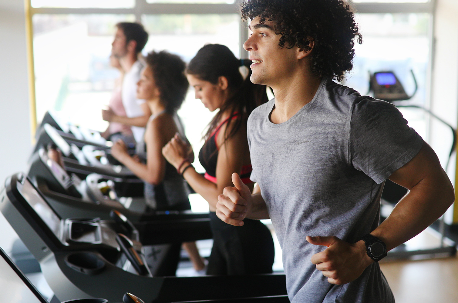 Group of people working out on treadmills
